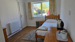 a bedroom with a bed and a table and a window at Snowdonia Mountain Lodge in Bethesda +67 photos