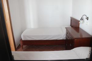 a small bedroom with two beds and a dresser at Residence Hotel Torresilvana in Vieste