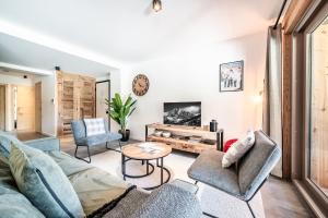 a living room with a couch and chairs and a table at Apartment Montami, Châtel - by EMERALD STAY in Châtel