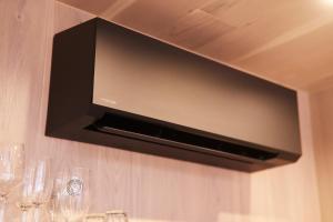 a flat screen tv hanging on a wall at HANNAH Mirror Tiny House in Den Bosch
