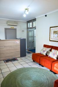 a living room with a couch and a table at Cecil John Rhodes Guest house in Kimberley