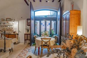 a dining room with a table and a window at Casa Arizo, Hotel Boutique & Bike Friendly in Oropesa del Mar