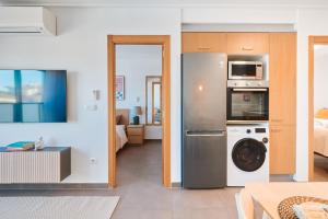 a kitchen with a washer and dryer in a room at Las Dunas 213 - by Welcomely in Oliva