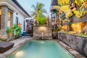 a swimming pool in front of a house with a mural at Meliora bali villa in Ubud