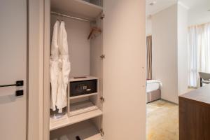 a room with a closet with a tv in it at ZUMMA Hotel Almaty in Almaty +91 photos