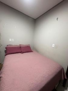 a bedroom with a bed with a pink blanket at Casa Timon in Timon