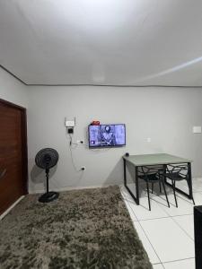a room with a table and a tv on the wall at Casa Timon in Timon