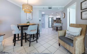 a kitchen and living room with a table and chairs at Phoenix III 3126 in Orange Beach
