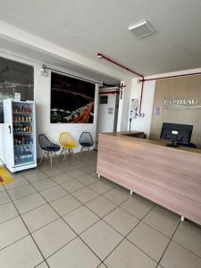 a store with chairs and a counter in a room at Pousada Tambaú in São Luís