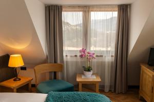 a hotel room with a bed and a window at Hotel Studio in Veliko Tŭrnovo