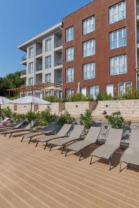 a row of lounge chairs in front of a building at Adriatic Heights Holiday Apartments in Kavač