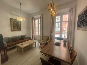 a living room with a couch and a table at Catedral Larios Centro in Málaga