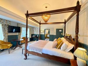 a bedroom with a large canopy bed in a room at The Holt Hotel in Steeple Aston +55 photos