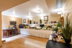 a kitchen with a counter with food on it at Hotel Studio in Veliko Tŭrnovo