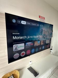 a flat screen tv hanging on a wall at Flat JK 201 in Juazeiro do Norte