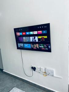 a flat screen tv hanging on a wall at Haven stay in Kiambu