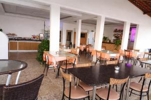 a restaurant with tables and chairs and a counter at Pousada Tambaú in São Luís