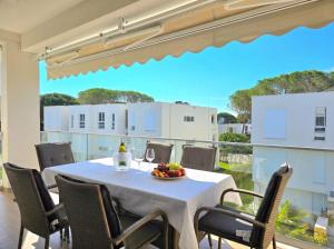a table with a bowl of fruit on a balcony at Bay Breeze 293 in Lalzit Bay