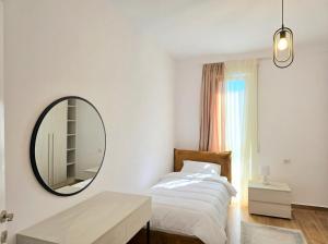 a bedroom with a bed and a mirror on the wall at Bay Breeze 293 in Lalzit Bay