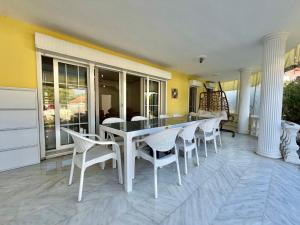 a dining room with a table and chairs at Dalyan Grand Garden in Ortaca