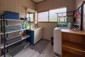 a small bathroom with a sink and a washing machine at Bunkyo in Naoshima +39 photos