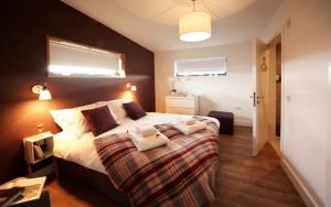 a bedroom with a large bed and two windows at Jog Lodge 5 By Together Travel - 3 Bed in John O Groats