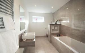 a bathroom with a tub and a sink at Jog Lodge 5 By Together Travel - 3 Bed in John O Groats