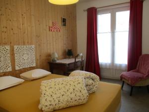 a room with a table and two chairs and a window at La Source - 85 m2 & terrasse privée in Orcival