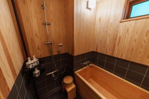 a bathroom with a bath tub and a toilet at NEKO no TSUKI in Takayama +61 photos