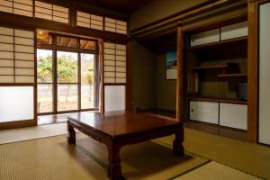 a room with a wooden table and a window at Bunkyo in Naoshima