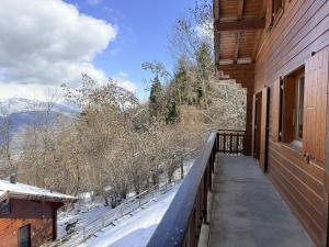 a balcony of a house with snow on the ground at Fontannets 001 COSY & MOUNTAIN chalet 10 pers in Veysonnaz