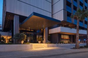 a building with a palm tree in front of it at Hotel Sumratin in Dubrovnik +45 photos