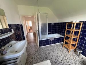 a bathroom with a sink and a shower and a tub at Hotel Restaurant Zum Schwan in Goch +50 photos