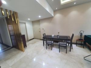 a dining room with a table and chairs at Stylish 2 BR Apartment in Ajman Residences Tower 4 in Ajman 
