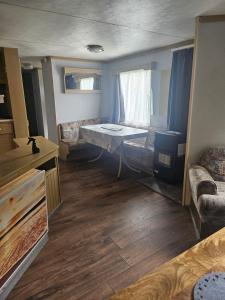 a small room with a table and a couch at An Tigin in Cahersiveen +3 photos