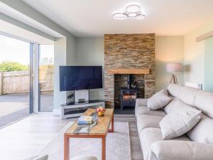 a living room with a couch and a fireplace at 3 Bed in Bideford oc-78796 in Northam