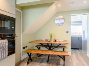 a dining room with a table and a microwave at 3 Bed in Bideford oc-78796 in Northam