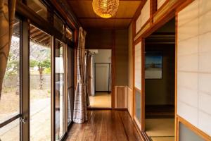 a hallway of a house with sliding glass doors at Bunkyo in Naoshima