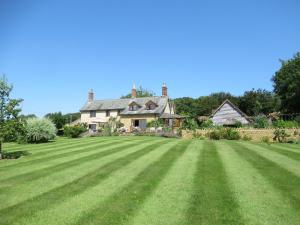 a large lawn in front of a house at Wooden Cabbage Barn in Dorchester +58 photos