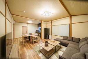 a living room with a couch and a table at 夢思苑 別府 in Beppu