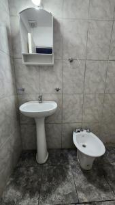 a bathroom with a sink and a mirror and a toilet at Norte Hogar in Salta