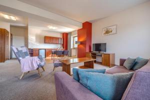 a living room with a couch and a table at Hotel Aviator - kompleks Silesia Ring in Kamień Śląski