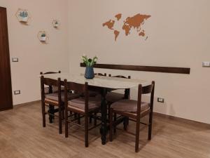 a dining room table and chairs with a map on the wall at Lissy Casa Vacanze in Lamezia Terme