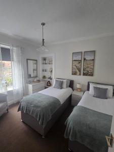 a bedroom with two beds and a window at Churchview in Townhill