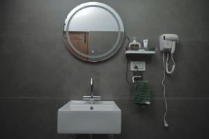 a bathroom with a white sink and a mirror at Inayat-Pet friendly boutique homestay in Dehradun +28 photos
