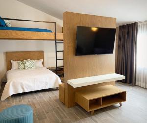 a bedroom with a bed and a flat screen tv at Hotel Kéri Inn in Guadalajara