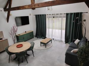 a living room with a table and a couch at Le petit marais in Le Mans