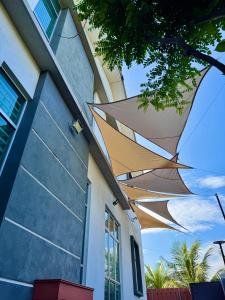 a group of umbrellas on the side of a building at A home with private pool, KebunStorey in Tangga Batu