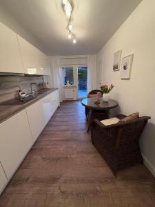 a kitchen with white cabinets and a table in a room at Jaegersruh Vicht in Fleuth +10 photos