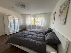 a bedroom with a large bed and a chandelier at Jaegersruh Vicht in Fleuth